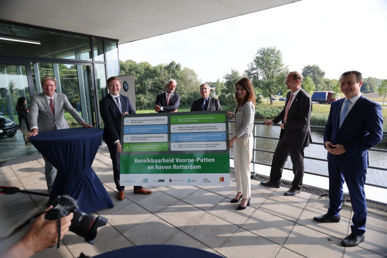Foto van minister Visser, wethouder Igor Bal (Nissewaard), burgemeester Foort van Oosten (Nissewaard), Peter Schop (Hellevoetsluis), Robert van der Kooi (Brielle) en burgemeester Gregor Rensen (Brielle).